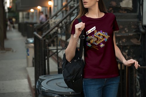 Burgundy shirt with an isometric factory of AbleGamers Monsters making the Joystick logo. 20 Years at the bottom. 