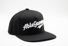 Load image into Gallery viewer, Black baseball cap w &quot;AbleGamers&quot; written in white. The writing is also raised so it has a puffy look
