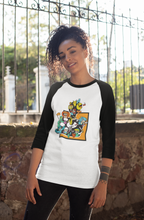 Load image into Gallery viewer, African-America women wearing a white shirt with a 3/4 sleeve. The sleeve and color of the shirt is black. The design on the shirt is the ablegamers joystick logo with video game characters coming out of the logo busting into the body of the shirt. The body of the shirt is white.
