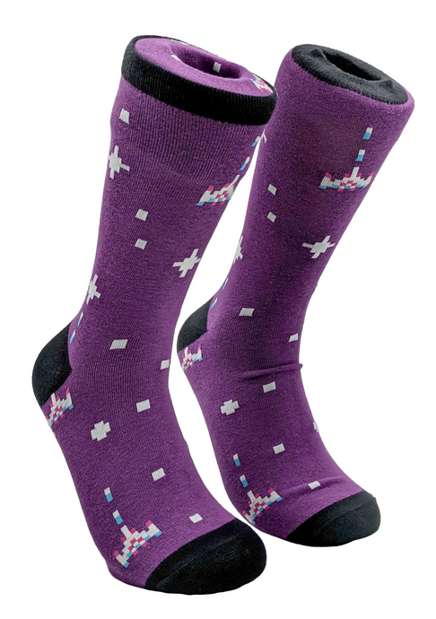 Purple dress socks with black toes and heal. On the purple is pixel space ships of white, pink, and blue. Also there are stars and squares that are being shot at by the ships.